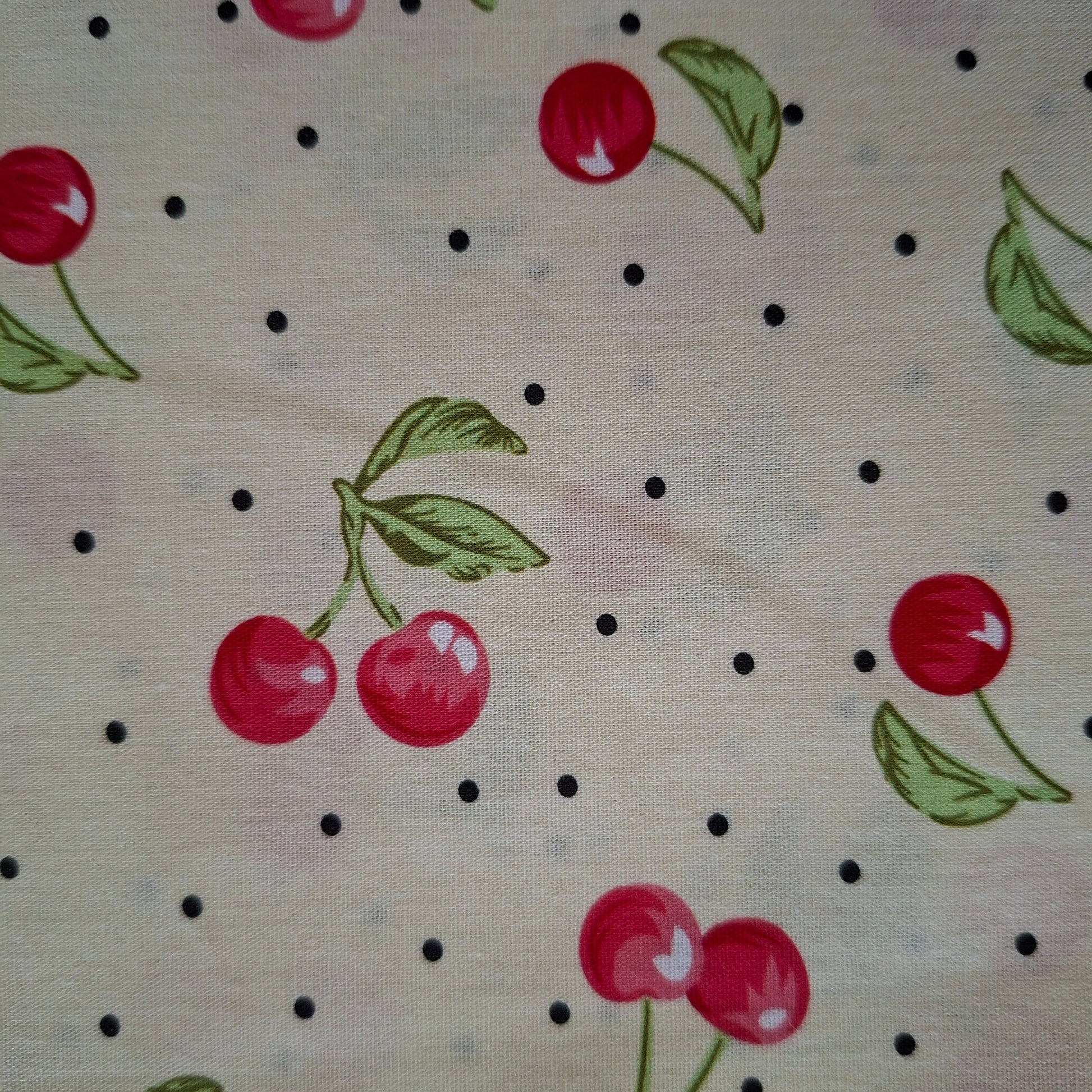 Fabric with cherry pattern on a beige background