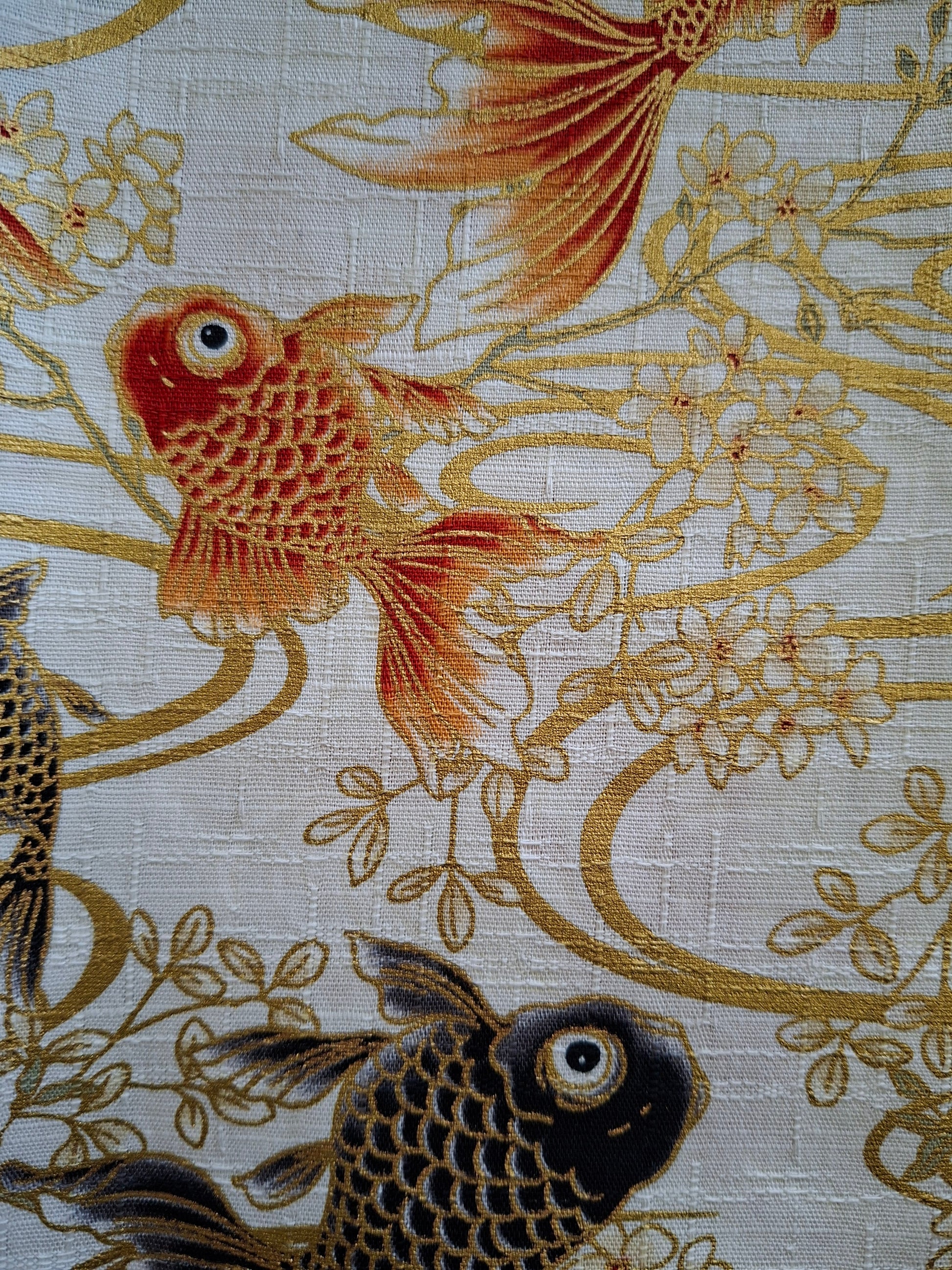 Decorative fabric with goldfish and floral patterns on a beige background